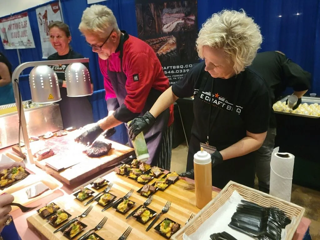The Fire Craft team preparing small plates together at a festival