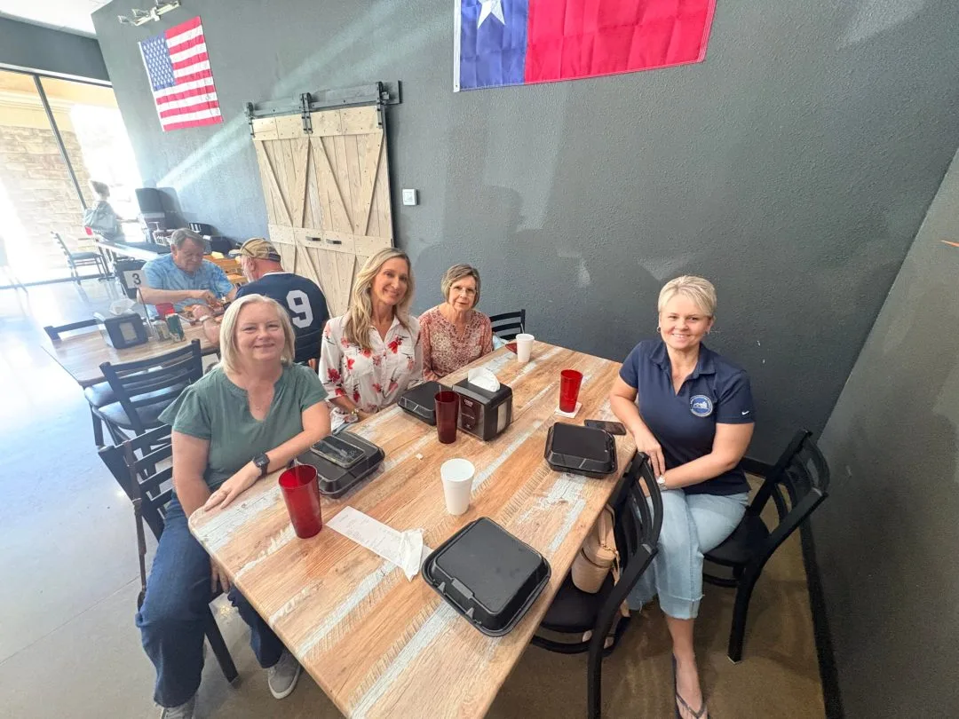 Four guests seated around a wooden table in the Fire Craft dining room