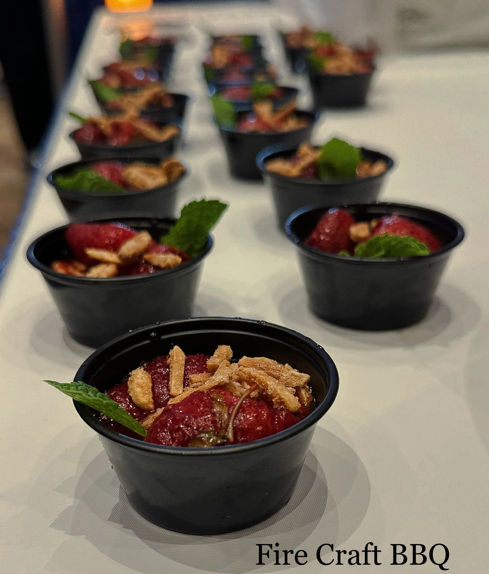 Individual dessert cups topped with strawberries and mint