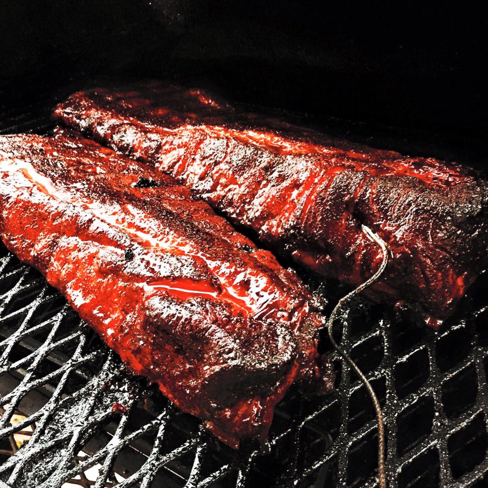 Fire Craft ribs smoking over hardwood